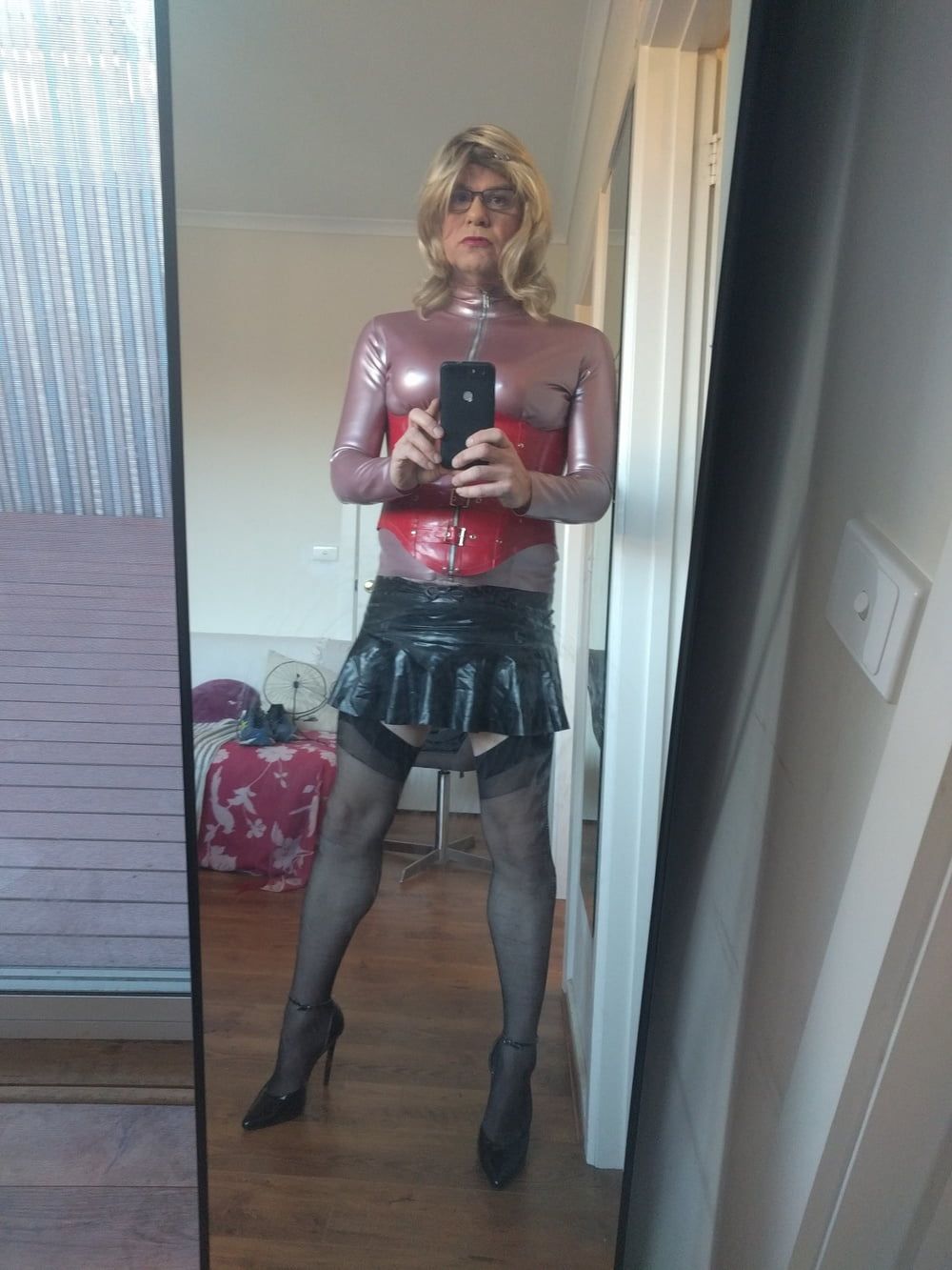 Back as a short blonde latex girl
