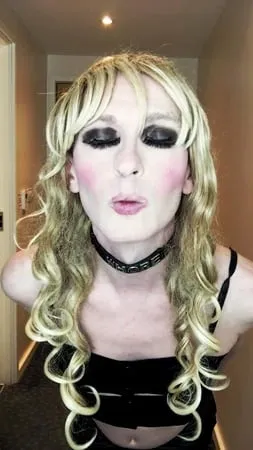 sissy crossdresser in black slut outfit posing         