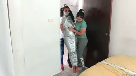 young girl duct tape wrapped like an egyptian mummy         