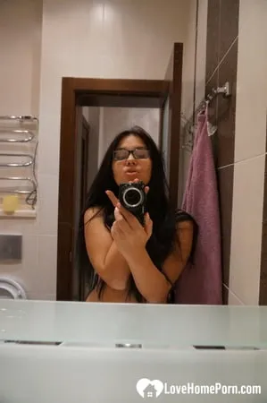 cute nerdy babe taking some hot selfies         