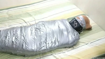 sexy girl trapped in ultra tight layered mummification         