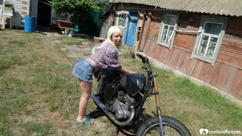 Blonde babe posing naked on a bike #4