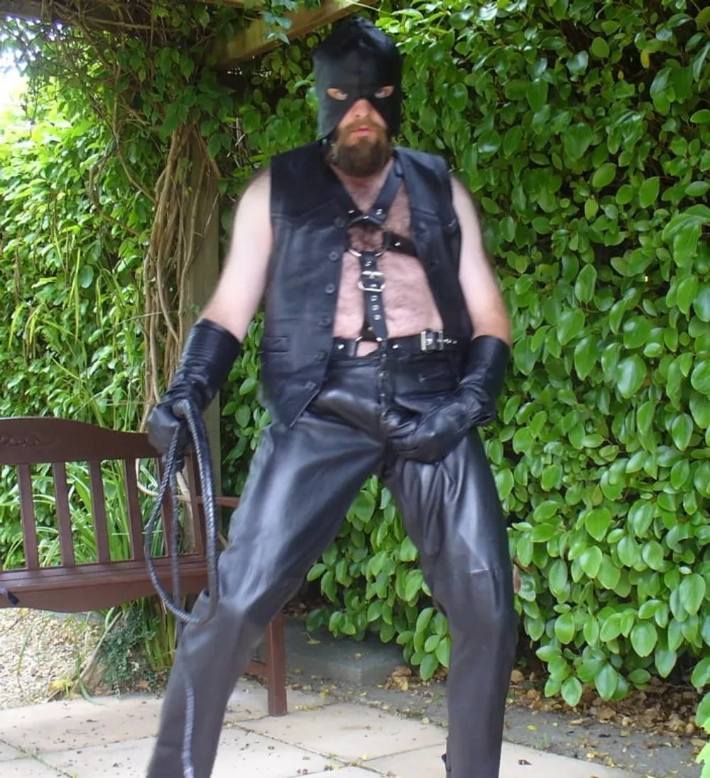 Leather Master outdoors in harness with whip