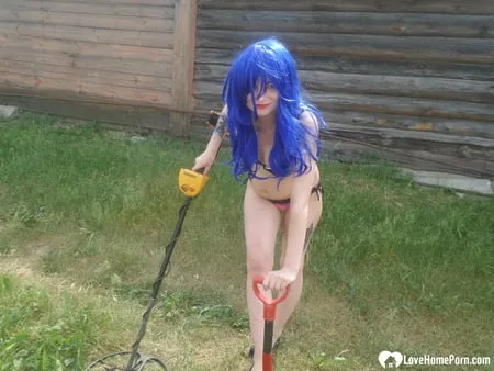 blue haired beauty showing her bust while gardening         