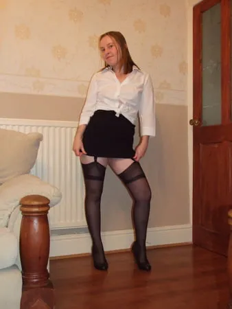 secretary in heels miniskirt stockings and suspenders         