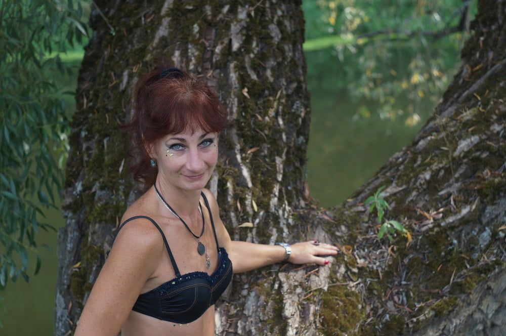 Black bikini near tree upon river