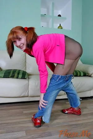 skinny redhead strips out of jeans in black pantyhose         