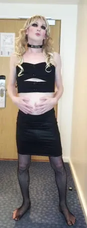 sissy crossdresser in black slut outfit posing         