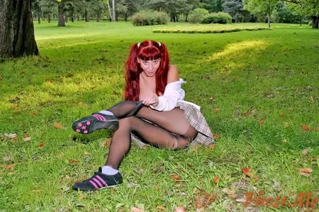 redhead outdoors in plaid skirt and black pantyhose         