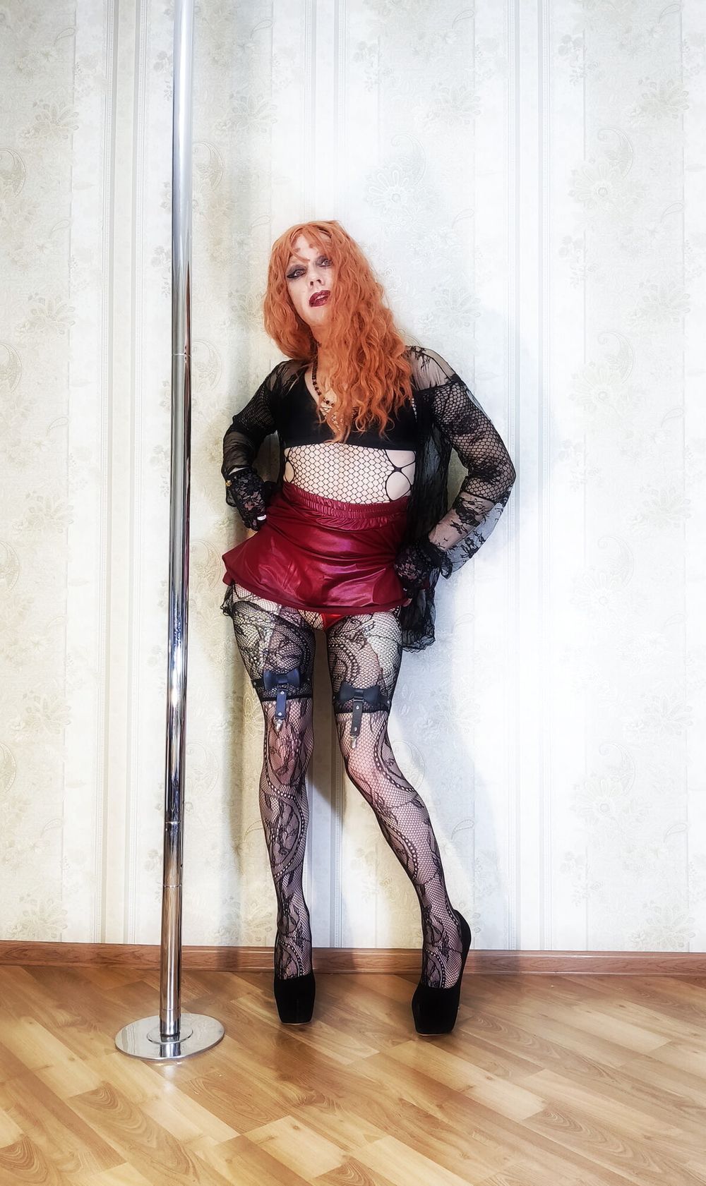 A bright red-haired girl in lace stockings and a cape &quot;makes #3