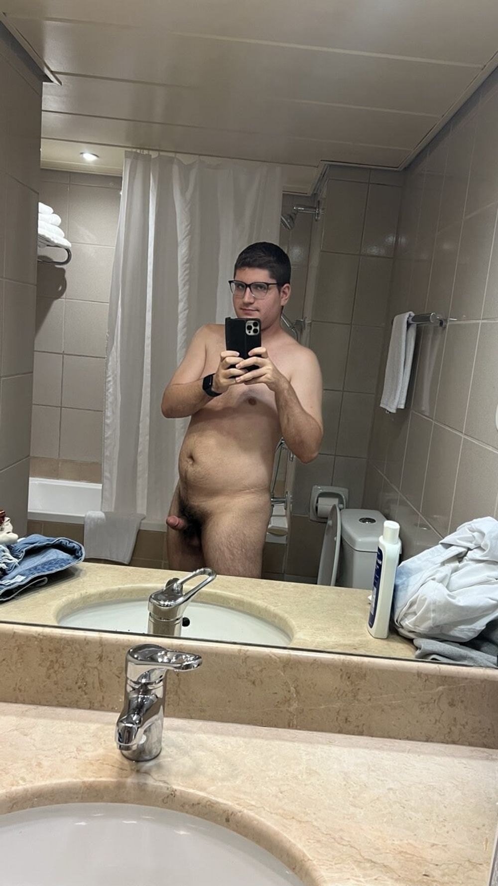 Naked in front of a mirror in the bathroom