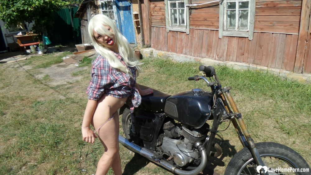 Blonde babe posing naked on a bike #16