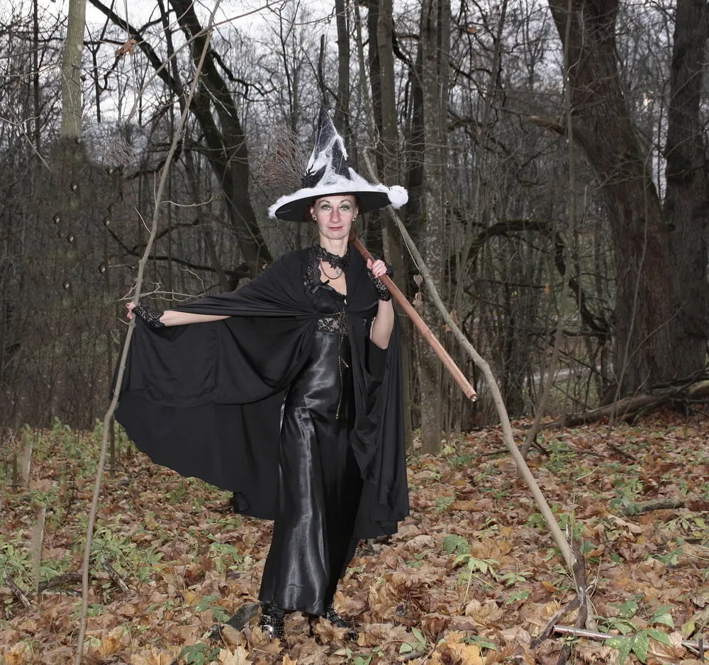 Witch with broom in forest