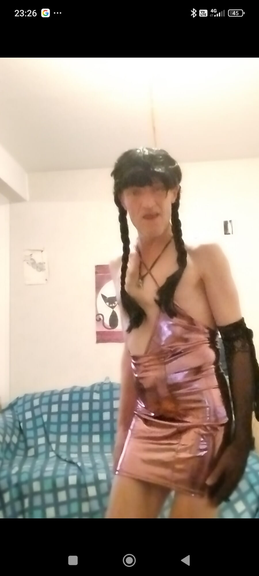 In long brown braids, and a disco pink dress! I tease you...