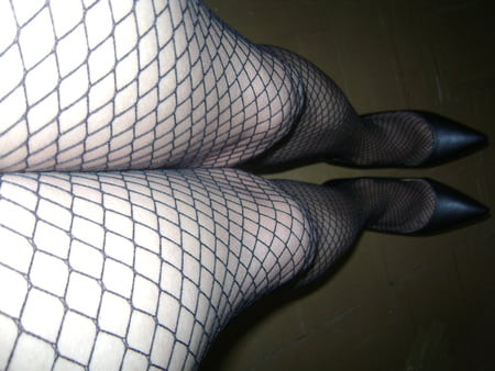 With black fishnet stockings on heels