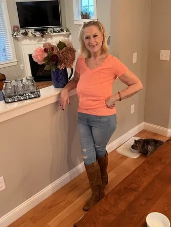 orange top and blue jeans         