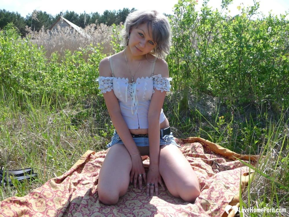 Gray-haired beauty posing naked outdoors on a blanket #7
