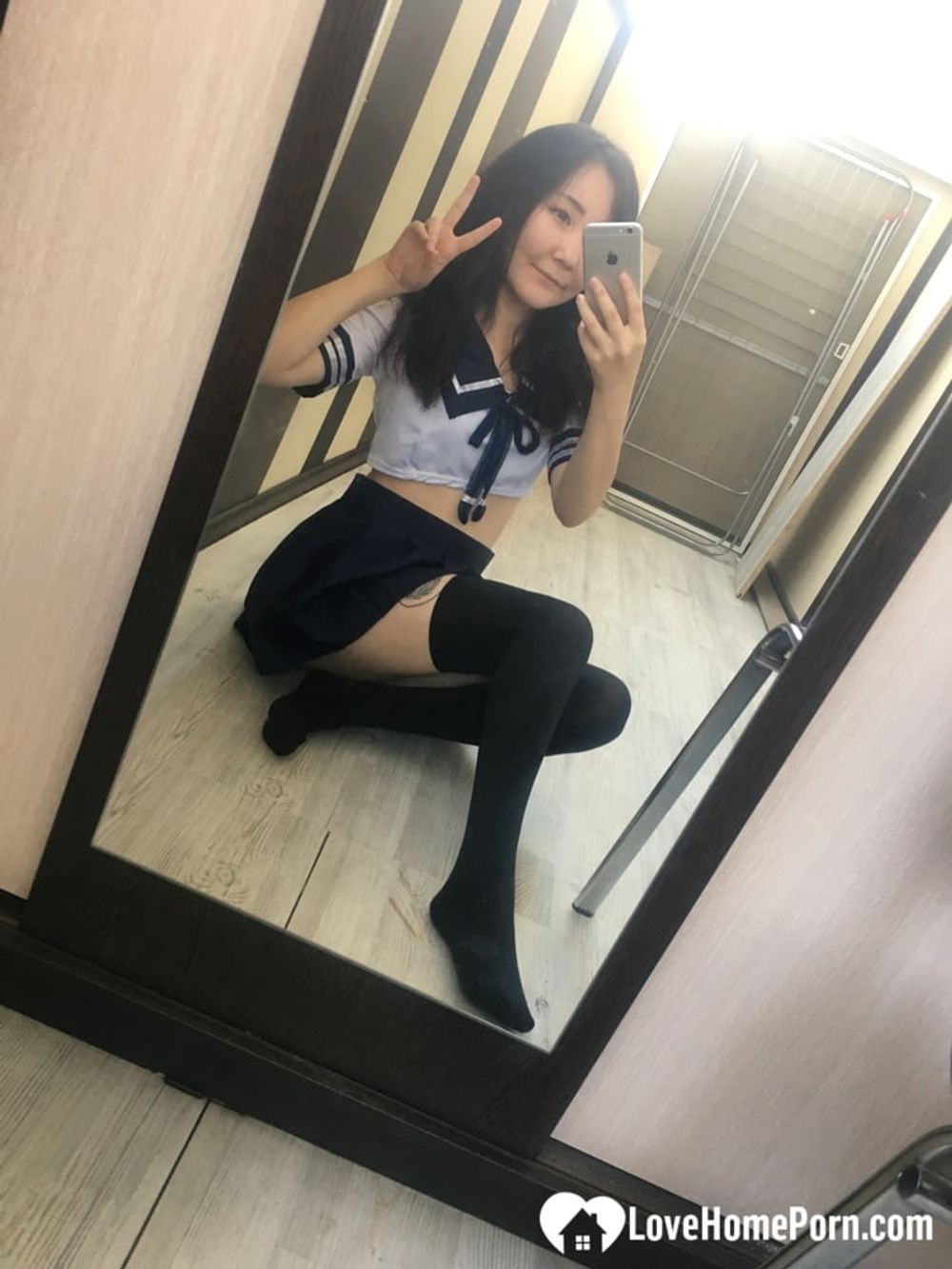 Asian schoolgirl flashing her pretty shaved pussy