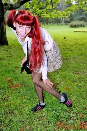 redhead outdoors in plaid skirt and black pantyhose         