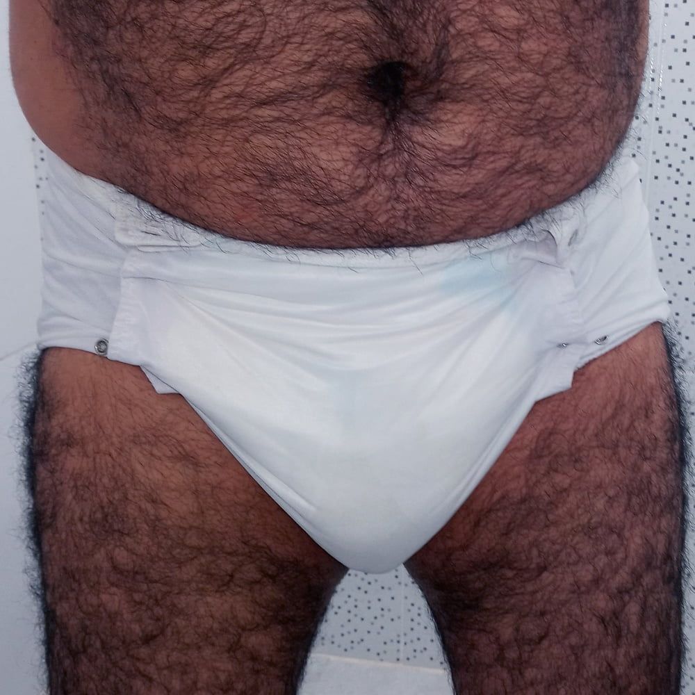 SHOWING WHITE DIAPER IN WORK BATHROOM.