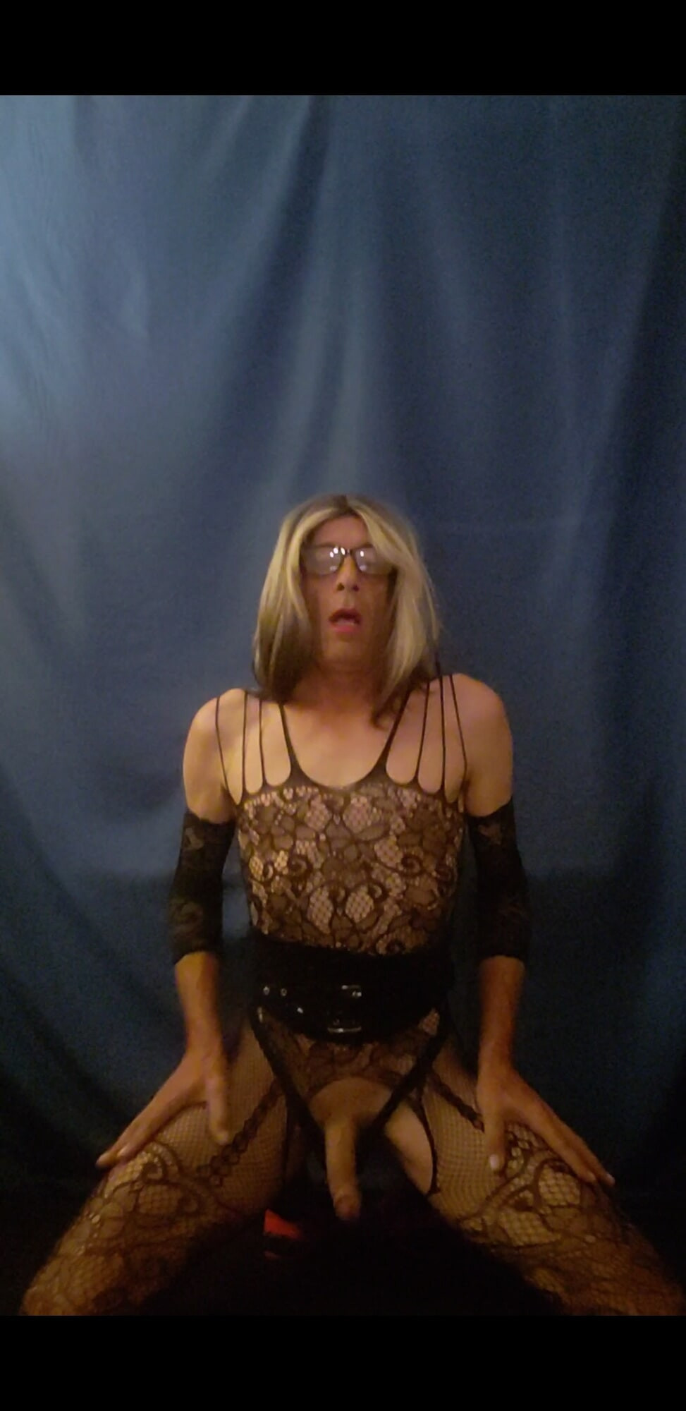 Sandy in a mesh bodystocking plays with her cock #9
