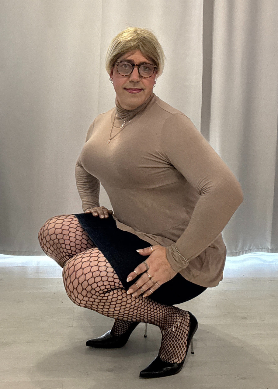 In a skirt and heels