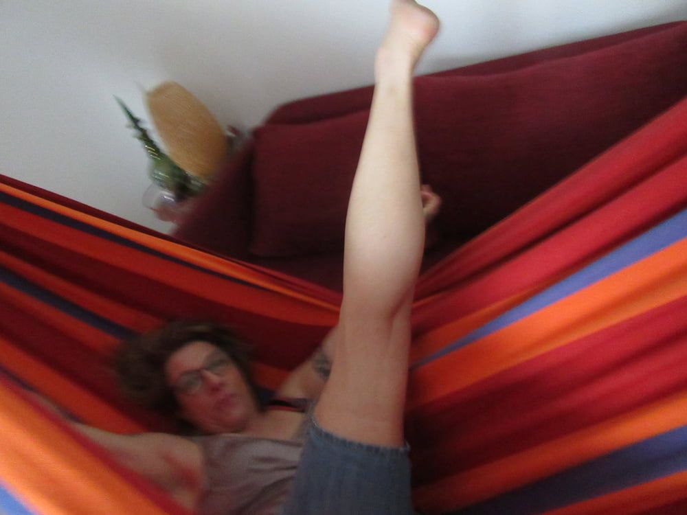 streching her legs in the hammock