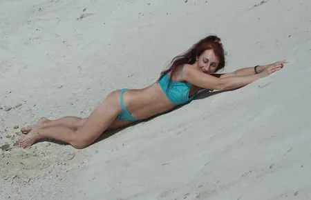 on white sand in turquos bikini         