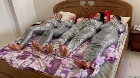   mummified girls barefoot in duct tape bondage         