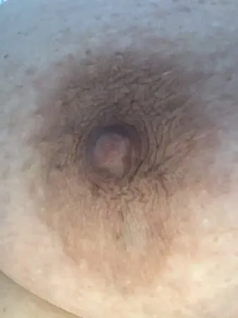 anatomy of a big brown bbw nipple close up and natural         