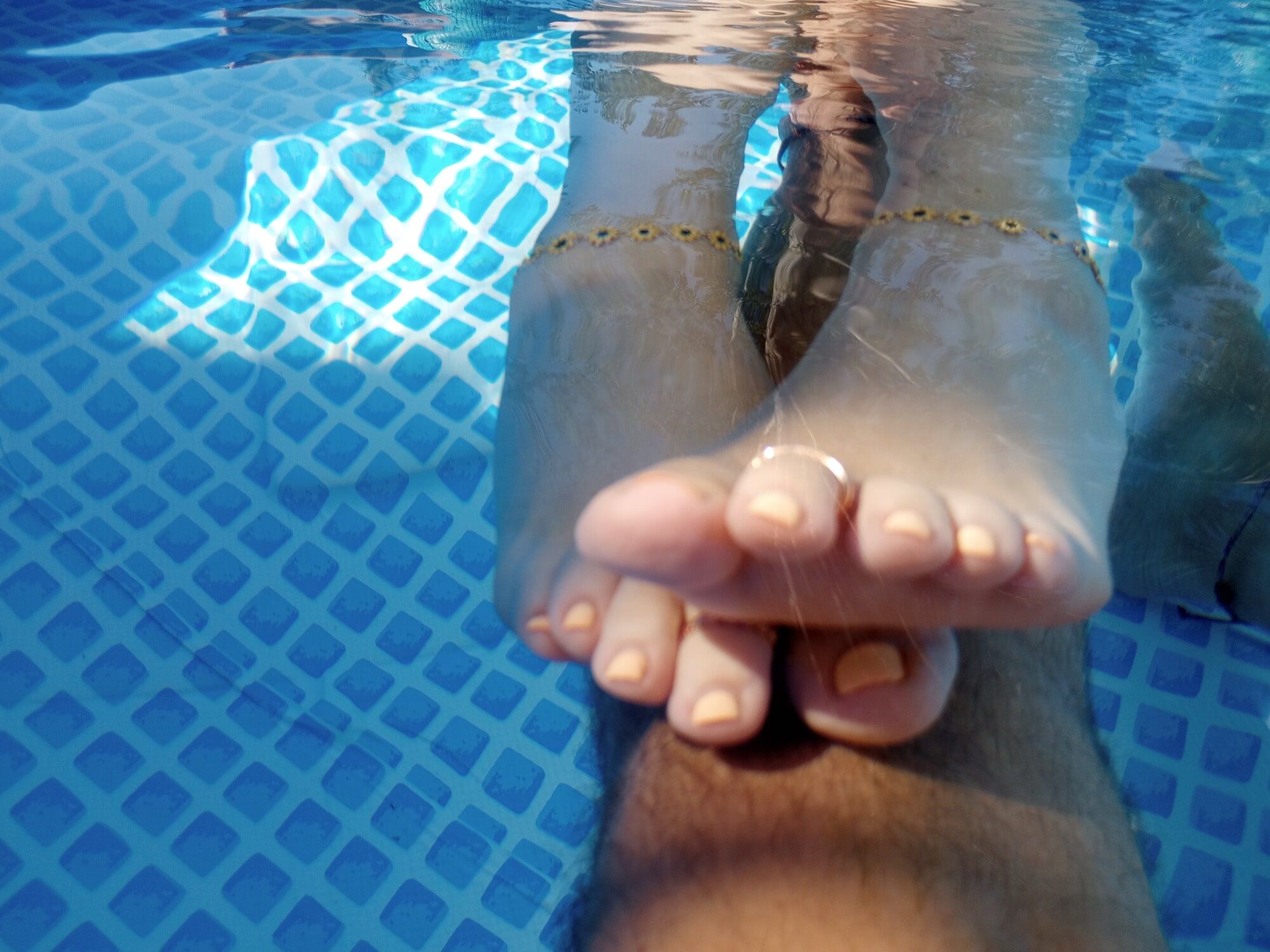 Showing off our pedicures in the pool