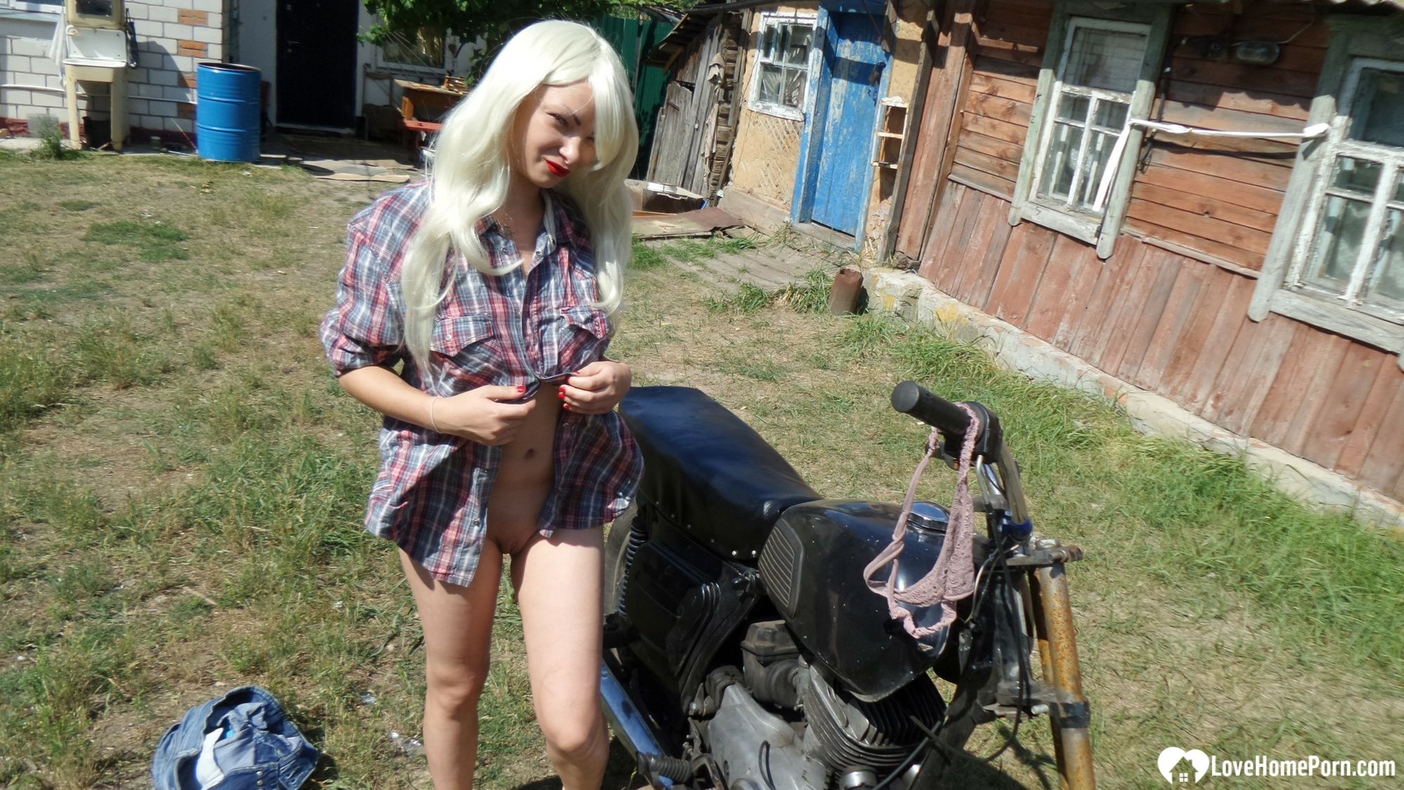 Blonde babe posing naked on a bike #21