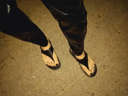 platform flip flops and latex pants         