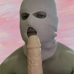 Playing with a dildo in a pink mask