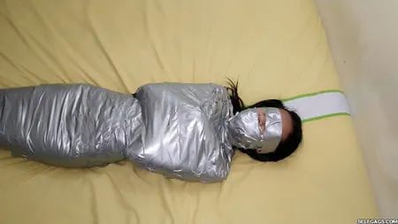 young girl duct tape wrapped like an egyptian mummy         