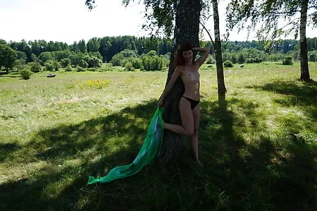 near the tree with green shawl        