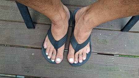 Painted male toes and flip-flops