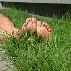 Beautiful bare feet on a summer walk in the park