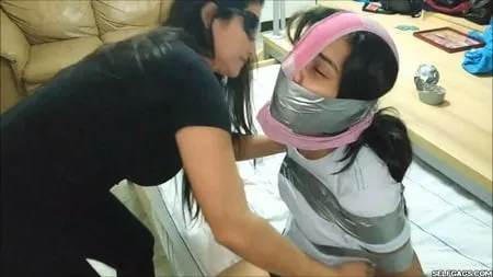 panty hooded girl gagged with socks and tape         