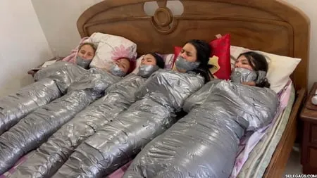   mummified girls barefoot in duct tape bondage         