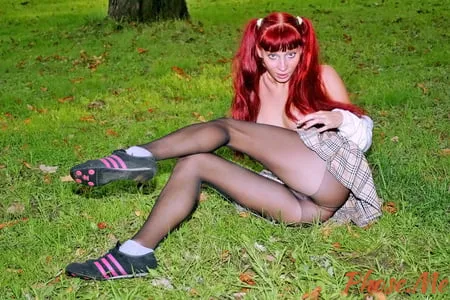 redhead outdoors in plaid skirt and black pantyhose         