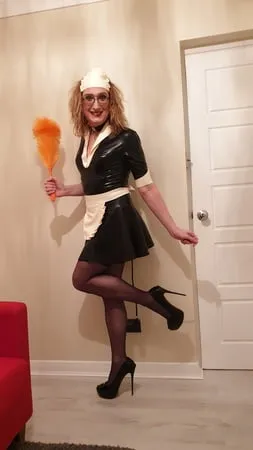 latex maid with a pump up anal plug stockings and heels         