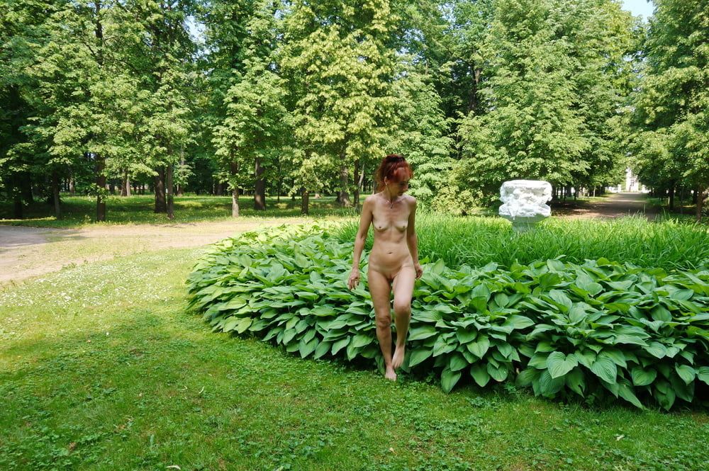 Naked in the grass by the vase