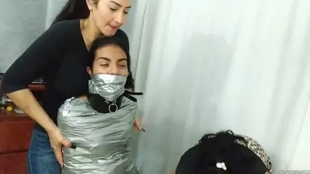 heavily duct tape mummified by crazy bondage women         