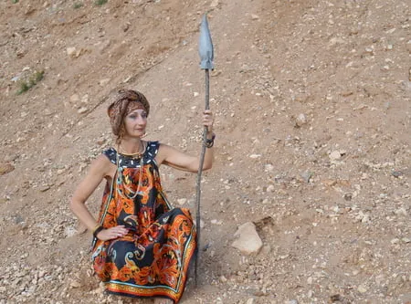 with spear wearing in colorful dress         