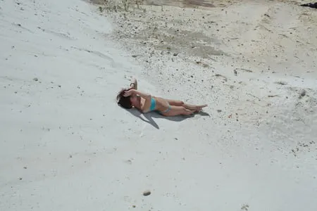 on white sand in turquos bikini         