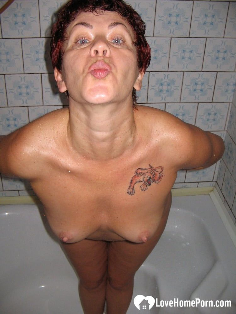 Redhead MILF pisses and takes a shower #12
