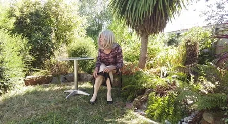 crossdress enjoying morning sun in garden         