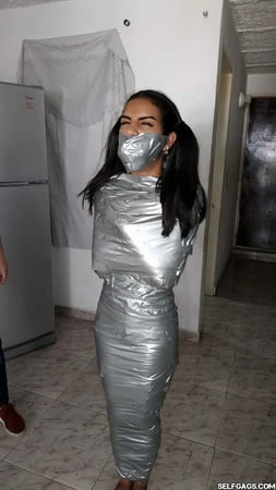 young girl duct tape wrapped like an egyptian mummy         