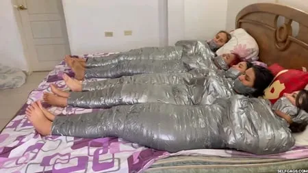   mummified girls barefoot in duct tape bondage         